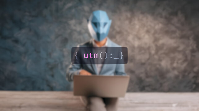 Cybersecurity concept utm on foreground screen, hacker silhouette hidden with low poly style mask. Vulnerability and attack on colored code editor. Text in English, English text
