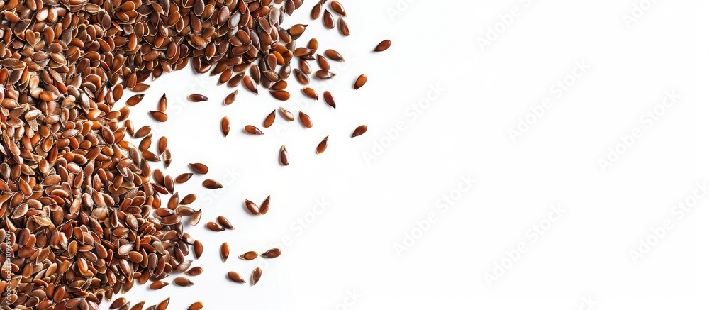 Poster Flax seeds scattered on the edge of a frame on white backdrop with copy space image