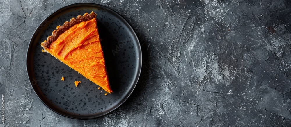 Poster Top view of a vegan raw carrot cake on a gray stone surface with copy space and selective focus showcasing a slice of healthy homemade cake
