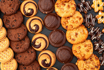 Mix of cookies . Many unhealthy snacks . Top view