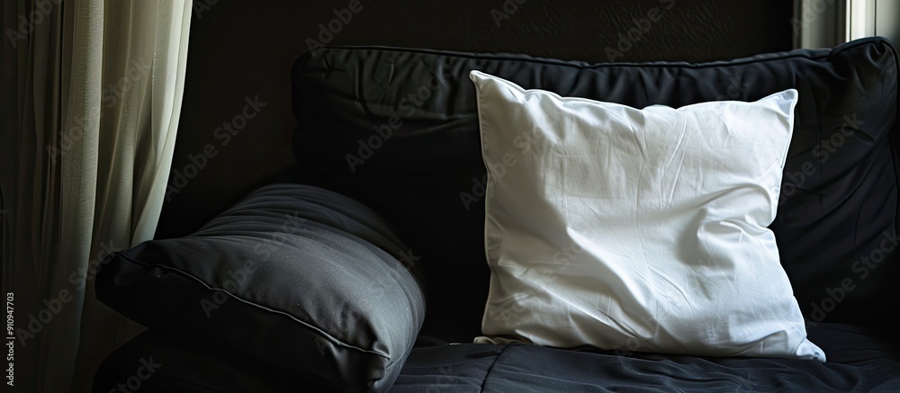 Aufkleber Copy space image featuring a white pillow centered on a black couch for a clean sophisticated look