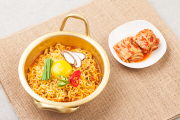  An instant food made by steaming noodles, frying them in oil, and then drying them. Add powdered soup separately.