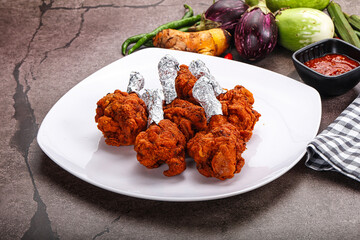 Indian cuisine glazed chicken lollipop
