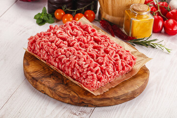 Raw minced beef meat over board