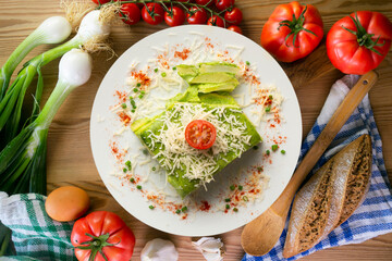 Baked potatoes with spinach bechamel and cheese.