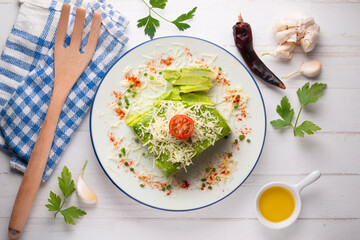 Baked potatoes with spinach bechamel and cheese.