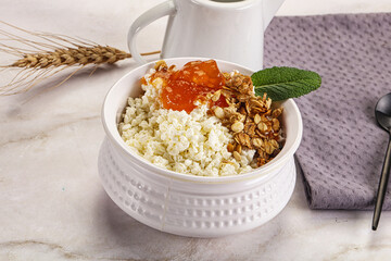 Curd with granola and orange jam