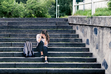 Sad college student at school. Anxiety or stress of youth. Abuse or harassment victim. Unhappy...