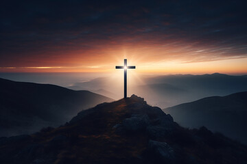 Silhouette of a Christian cross on a mountain top with sunset