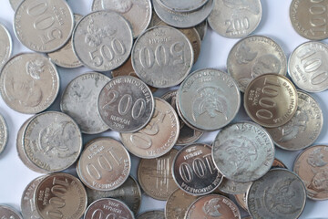 Indonesian Rupiah coins on a white background, the official currency of Indonesia.