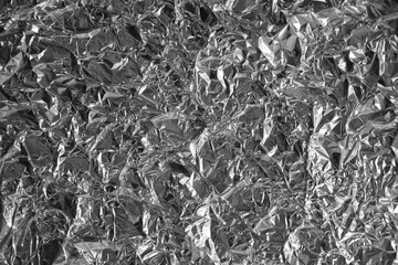 Processed collage of shiny metal silver gray foil crumpled packaging material texture