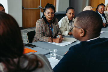 Diverse group of colleagues discussing in a conference room