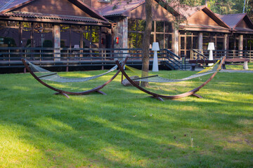 Two comfortable hanging wicker chairs on the front lawn. A cozy place to relax in the forest....