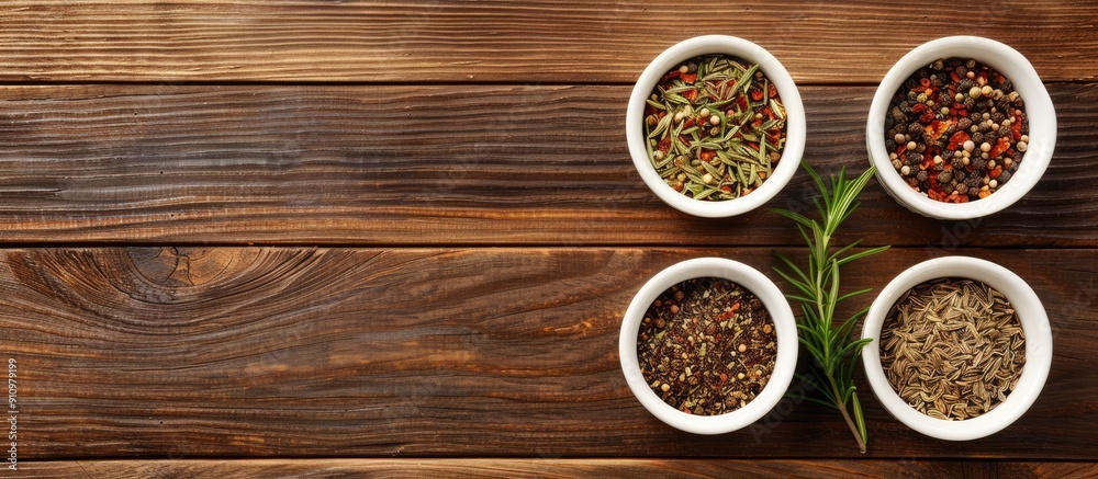 Poster top view of spices in small white bowls on a brown wooden backdrop suitable for pilaf ingredients wi