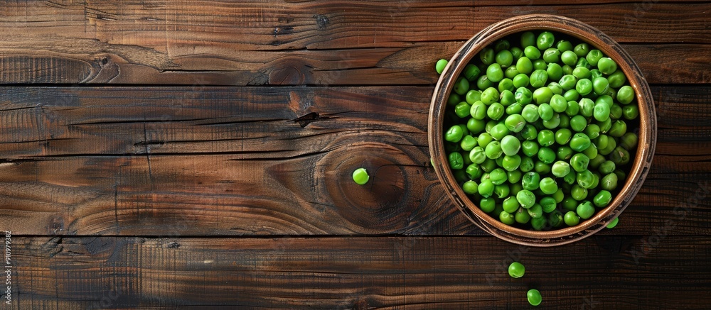 Poster Peas in a bowl on a wooden surface with a blank space for an image. copy space available