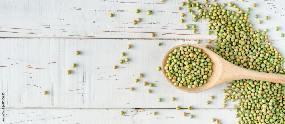 Poster Top down view of raw green buckwheat grains in a spoon on a white wooden surface with room for text Additional copy space image available