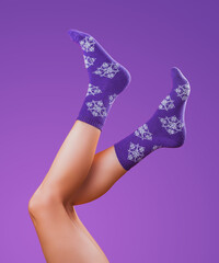 legs in christmas socks on brownbackground