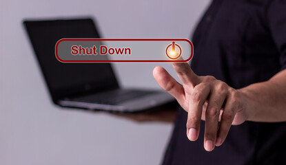 Young man hand touching laptop Shut Down button press power OFF