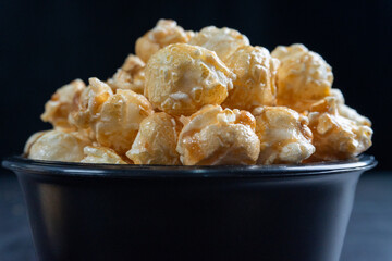 close shot of pile of popcorn in black bowl