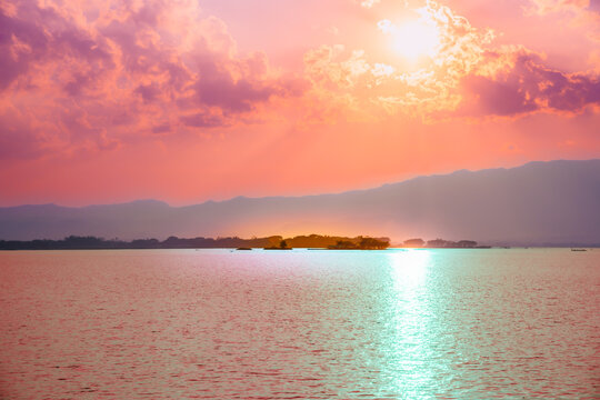 Wat Tilok Aram in Kwan Phayao Lake during sunset