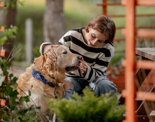 Teen Girl Plays With Golden Retriever In Gazebo During Spring