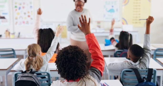 Children, back and hands raised at school for question, answer and learning at youth academy. Kids, education and teacher for development with sign for talking, quiz and scholarship in classroom