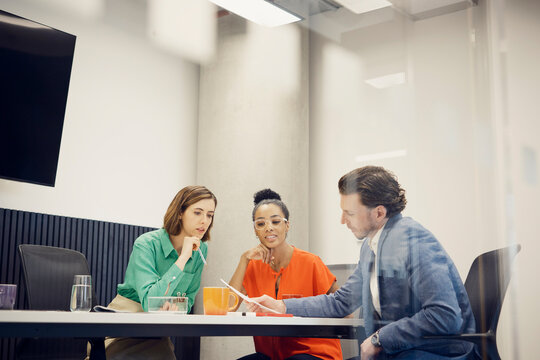 Multiracial business colleagues planning strategy in meeting at office