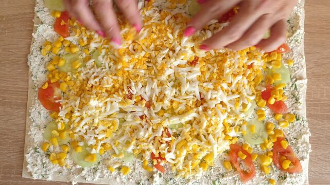 A boiled egg is rubbed on the lavash roll.