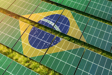 Solar farm superimposed with flag of Brazil. Symbolizing solar power and panel demand, renewable...
