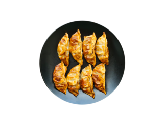 fried gyoza on a black plate, Top view, on transparent background
