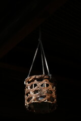 Candle hanging off rope in darkness