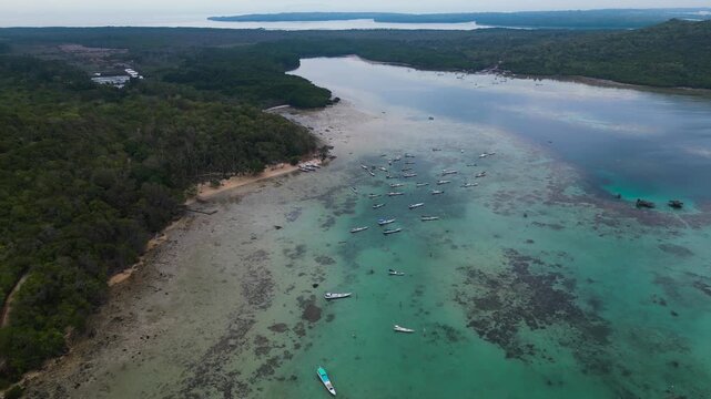 many fishing boats moored at a low tide sea in Alano Beach, Karimunjawa - Central Java, Indonesia