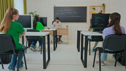 Engaged Computer Science Instructor Teaching in Modern Classroom