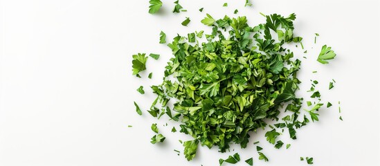 Obraz premium Chopped parsley leaves scattered on a white surface. Bright green leaves create a contrast with the background, emphasizing the freshness and naturalness of the product.