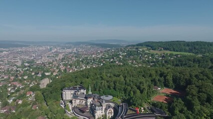 Aerial view over Swiss City of Zürich with woodland, cityscape and Lake Zürich on a sunny summer morning. Movie shot August 6th, 2024, Zurich, Switzerland.
