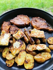 grilled sausages meat and potatoes