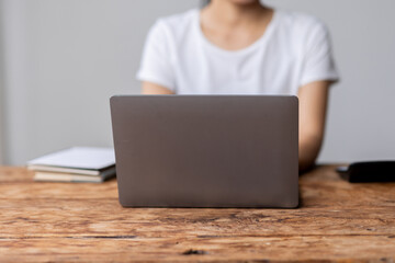 Close up of female hands while typing on laptop use calculator accountant 
