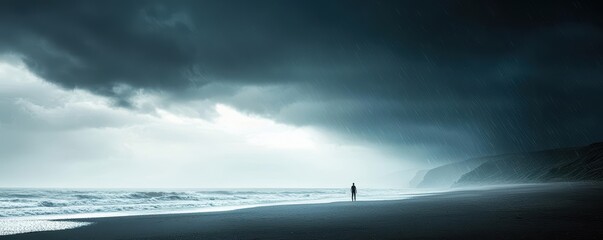 Solitary figure on a beach with stormy clouds and light breaking through.