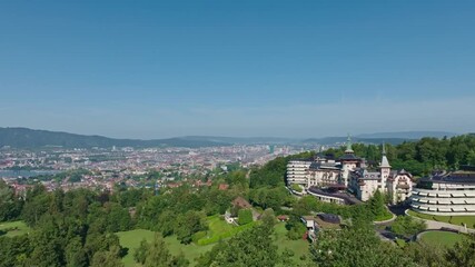 Aerial view over Swiss City of Zürich with woodland, cityscape and Lake Zürich on a sunny summer morning. Movie shot August 6th, 2024, Zurich, Switzerland.