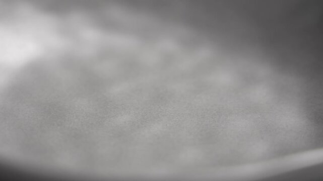 Empty ceramic gray plate with uneven textured surface close up. Rotation. Minimalist view