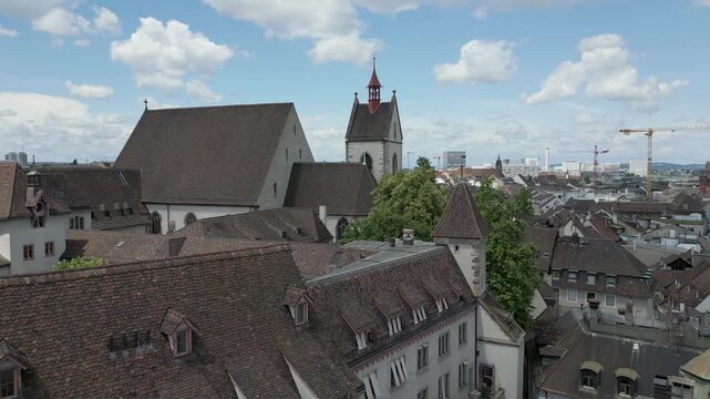 4K Drone Video of Church Bell Towers, Historic Buildings, and Construction Cranes on the Skyline of Basel, Switzerland (Dolly Backward)