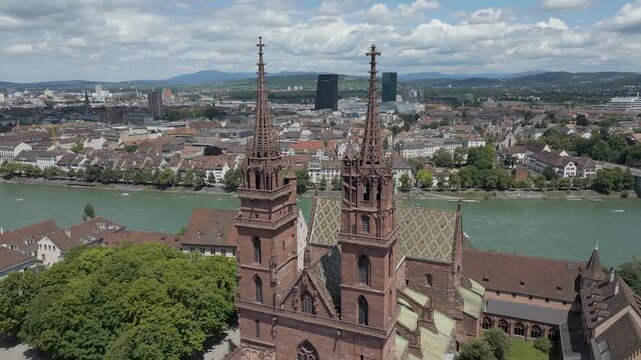 4K Drone Video of Historic Church with Twin Bell Towers in Basel, Switzerland with Modern Buildings across the Rhine River