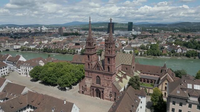 4K Drone Video of Gothic Church with Twin Bell Towers in Basel, Switzerland with Modern Buildings across the Rhine River