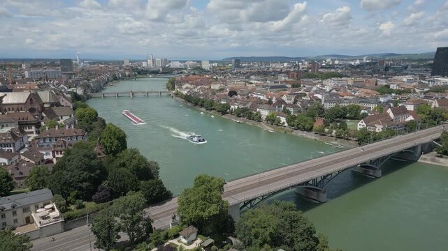 4K Drone Video of Tugboat Pulling Petroleum Barge Towards the Wettsteinbr&uuml;cke Bridge over the Rhine River in Basel, Switzerland (Dolly Forward)
