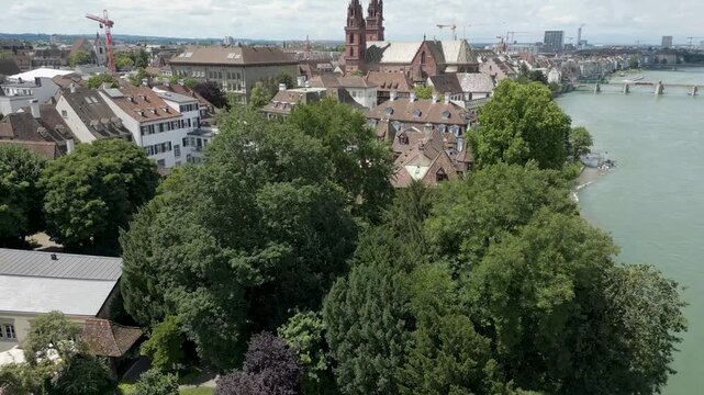 4K Drone Video of Historic Church on the banks of the Rhine River in Downtown Basel, Switzerland (Pedestal Up)
