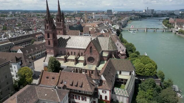 4K Drone Video of Church with Two Bell Towers on the banks of the Rhine River in Downtown Basel, Switzerland (Track Left)