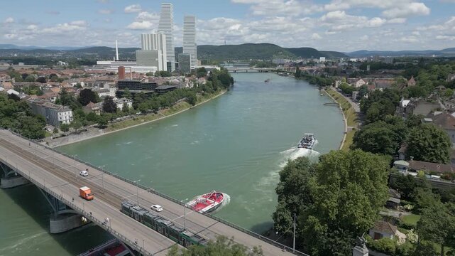 4K Drone Video of Tugboat Pulling Petroleum Barge Under the Wettsteinbr&uuml;cke Bridge over the Rhine River in Basel, Switzerland
