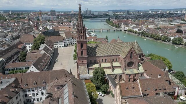 4K Drone Video of Historic Church with Twin Spires on the banks of the Rhine River in Downtown Basel, Switzerland (Track Left)