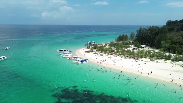 Many tourists enjoying their holiday on Bamboo Island in Krabi province, as seen from a drone 4K video