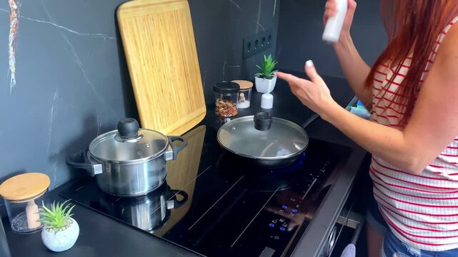 Woman receives burn injury hand by hot pan during cooking food,dinner,applying medicinal ointment panthenol,medicine treatment at kitchen,first aid at home
